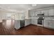 Open-concept kitchen with gray cabinets, granite countertops, and stainless appliances at 1964 Hollywood Nw Rd, Atlanta, GA 30318