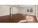 Large living room featuring hardwood floors, white walls, and a front entry door at 1964 Hollywood Nw Rd, Atlanta, GA 30318