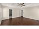 Spacious primary bedroom with tray ceiling, ceiling fan, and dark hardwood floors at 1964 Hollywood Nw Rd, Atlanta, GA 30318