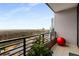 Balcony view overlooking the city skyline and trees, with black metal railing and red sphere at 750 Park Ne Ave # 19E, Atlanta, GA 30326