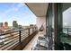 Balcony featuring city views, outdoor seating, and sleek black railings, with a hammock chair at 750 Park Ne Ave # 19E, Atlanta, GA 30326
