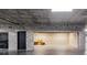 A two car garage space featuring concrete walls and a neutral-colored epoxy floor at 750 Park Ne Ave # 19E, Atlanta, GA 30326