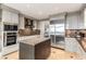 Modern kitchen with stainless steel appliances, island, countertops, and view into adjacent room at 750 Park Ne Ave # 19E, Atlanta, GA 30326