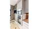 Modern kitchen with stainless steel built-in oven and microwave, complemented by neutral backsplash and cabinetry at 750 Park Ne Ave # 19E, Atlanta, GA 30326