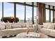 Cozy living area featuring plush sofas, decorative pillows, and large windows framing the city skyline at 750 Park Ne Ave # 19E, Atlanta, GA 30326