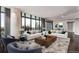 Bright living room with floor to ceiling windows, hardwood floors, and two white sofas with decorative pillows at 750 Park Ne Ave # 19E, Atlanta, GA 30326