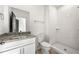 Bathroom with granite countertop vanity, tiled shower, and modern fixtures, offering a clean and stylish design at 1098 Wedgewood Nw Dr, Atlanta, GA 30318