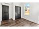 Bedroom featuring hardwood floors, a split unit AC system, dark doors, and a window offering natural light at 1098 Wedgewood Nw Dr, Atlanta, GA 30318