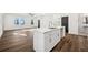 Modern kitchen island with a sink and stainless steel faucet, connecting seamlessly to a large living space at 1098 Wedgewood Nw Dr, Atlanta, GA 30318