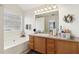 Bright bathroom featuring a soaking tub and vanity with great lighting and storage at 1902 Elm Park Dr, Hampton, GA 30228