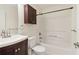 Neat bathroom with a bathtub, shower combo, vanity, and dark wood cabinet at 1902 Elm Park Dr, Hampton, GA 30228