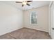 Simple bedroom with carpet, ceiling fan, natural light from the large window at 1902 Elm Park Dr, Hampton, GA 30228