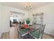 Open dining room featuring hardwood floors, stylish furniture, and a view into the living area at 1902 Elm Park Dr, Hampton, GA 30228