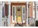 Inviting front entry showcasing a brick facade, decorative pillars, and a bright yellow door at 1902 Elm Park Dr, Hampton, GA 30228