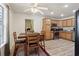Bright kitchen and dining area with natural wood cabinets, stainless steel appliances, and a view into the laundry room at 1902 Elm Park Dr, Hampton, GA 30228