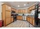 Traditional kitchen featuring stainless steel appliances, light wood cabinetry, and ample counter space at 1902 Elm Park Dr, Hampton, GA 30228