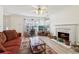 Bright and inviting living area featuring a fireplace, lots of natural light, and modern flooring at 1902 Elm Park Dr, Hampton, GA 30228
