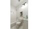 Clean white bathroom featuring a tub, toilet, and glass vessel sink at 3028 E Point St, Atlanta, GA 30344