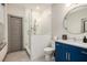 Modern bathroom with glass shower, sleek blue vanity, and contemporary round mirror at 589 Broadview Ne Pl, Atlanta, GA 30324