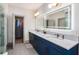 Modern primary bath with double vanity, walk-in closet and neutral color palette at 589 Broadview Ne Pl, Atlanta, GA 30324
