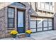 Welcoming front entry with a glass panel door, brick facade, and attached garage at 589 Broadview Ne Pl, Atlanta, GA 30324