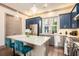 Bright kitchen features a large island, stainless steel appliances, and stylish pendant lighting at 589 Broadview Ne Pl, Atlanta, GA 30324