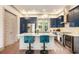 Spacious kitchen with island, breakfast bar, stainless appliances, and blue cabinets at 589 Broadview Ne Pl, Atlanta, GA 30324