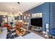 Stylish living room with eye-catching blue geometric accent wall adjacent to a gourmet kitchen at 589 Broadview Ne Pl, Atlanta, GA 30324
