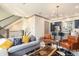 Open-concept living room flows into the kitchen with modern fixtures and cozy seating at 589 Broadview Ne Pl, Atlanta, GA 30324