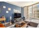 Beautiful living room with a modern blue wallpapered wall and sun-filled windows at 589 Broadview Ne Pl, Atlanta, GA 30324