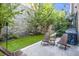 Cozy outdoor patio with a stone wall, grill, and comfortable seating area at 589 Broadview Ne Pl, Atlanta, GA 30324