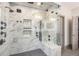 Luxurious walk-in shower with marble tile, multiple shower heads, and glass enclosure at 589 Broadview Ne Pl, Atlanta, GA 30324
