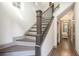 Elegant staircase with dark wood treads, white risers, and decorative metal railing at 589 Broadview Ne Pl, Atlanta, GA 30324
