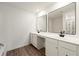 Bathroom with a white vanity and double sinks, complemented by square mirrors at 962 Edwin Ln, Sugar Hill, GA 30518