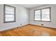 Empty bedroom with hardwood floors, two windows, and fresh white paint at 2446 Sunset Ne Dr, Atlanta, GA 30345