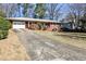 Classic home with a driveway, mature landscaping, and welcoming curb appeal at 2446 Sunset Ne Dr, Atlanta, GA 30345
