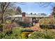 Charming single-story home featuring lush landscaping, a brick chimney, and a tranquil pond at 2446 Sunset Ne Dr, Atlanta, GA 30345