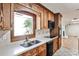 Traditional-style kitchen with wood cabinets, stone countertops, and a view from the window at 2446 Sunset Ne Dr, Atlanta, GA 30345