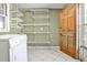Functional laundry room with shelving, tile flooring, and a convenient washer/dryer setup at 2446 Sunset Ne Dr, Atlanta, GA 30345