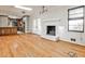 Bright living room featuring a white brick fireplace and beautiful hardwood floors at 2446 Sunset Ne Dr, Atlanta, GA 30345