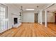 Cozy living room with hardwood floors, a white painted brick fireplace, and natural light at 2446 Sunset Ne Dr, Atlanta, GA 30345