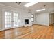 Open living room with a fireplace, hardwood floors, and natural light from French doors at 2446 Sunset Ne Dr, Atlanta, GA 30345