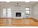 Bright living room with a white brick fireplace, hardwood floors, and skylights at 2446 Sunset Ne Dr, Atlanta, GA 30345