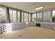 A sunroom with lattice work on the base of the walls and lots of windows to view the yard at 2446 Sunset Ne Dr, Atlanta, GA 30345
