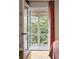 A light filled room features an open balcony with white rails and views of the lush, green outdoor space at 2574 Sugarplum Ne Ct, Atlanta, GA 30345