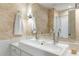 Modern bathroom boasts dual sinks, stylish vanity, and contemporary lighting against decorative wall with seamless integration at 2574 Sugarplum Ne Ct, Atlanta, GA 30345