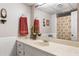 Well-lit bathroom with a spacious countertop, decorative plants, and a large mirror at 2574 Sugarplum Ne Ct, Atlanta, GA 30345