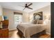 Cozy bedroom featuring a ceiling fan, hardwood floors, decorative pillows and a window with wooden blinds at 2574 Sugarplum Ne Ct, Atlanta, GA 30345