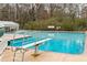 Community pool with marked lanes, diving board, and a backdrop of mature trees at 2574 Sugarplum Ne Ct, Atlanta, GA 30345
