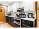 Well-lit kitchen showcasing modern appliances, white upper cabinets, and dark lower cabinets and backsplash at 2574 Sugarplum Ne Ct, Atlanta, GA 30345